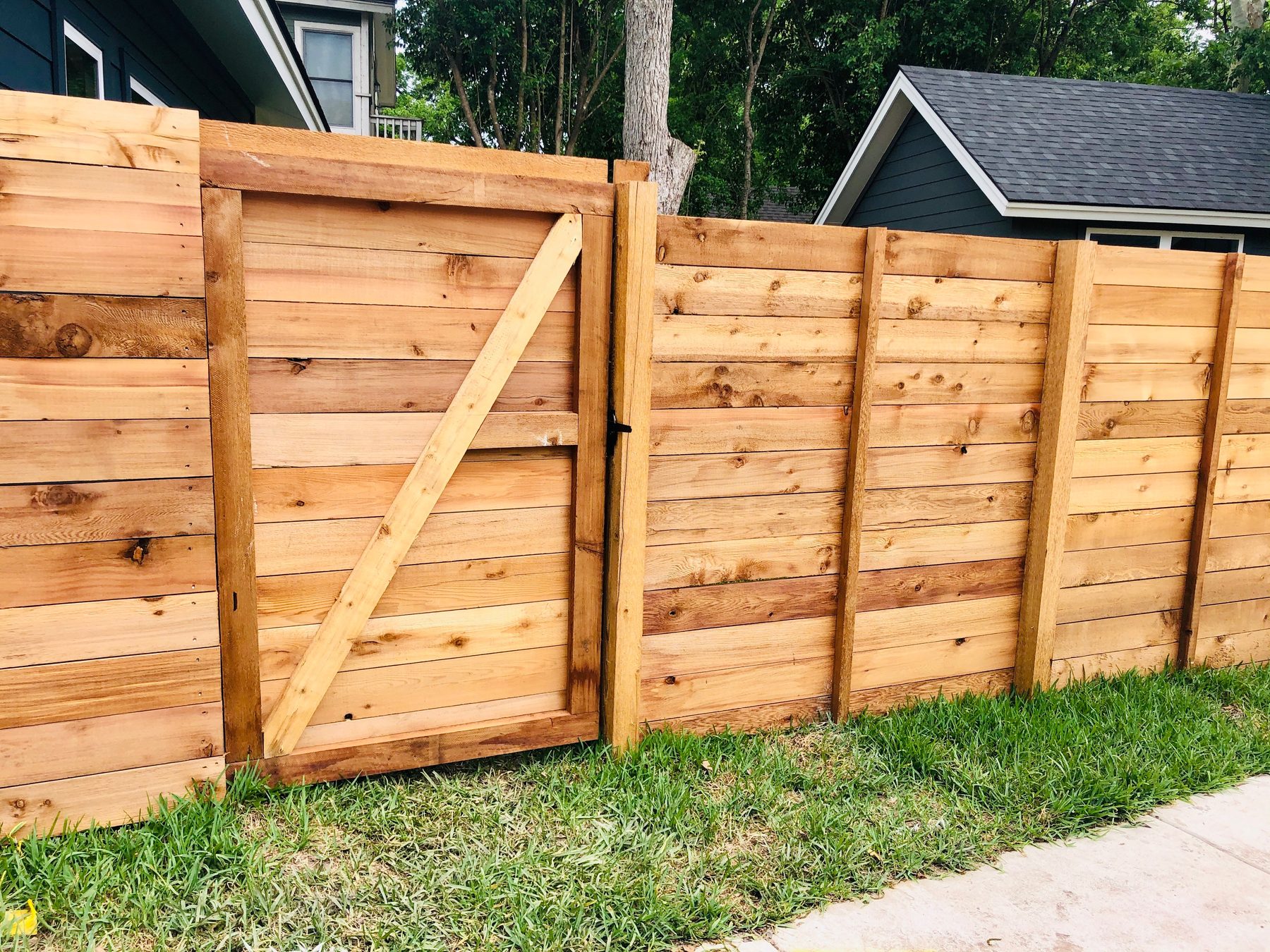 Horizontal wood fence and gate on a residential lot