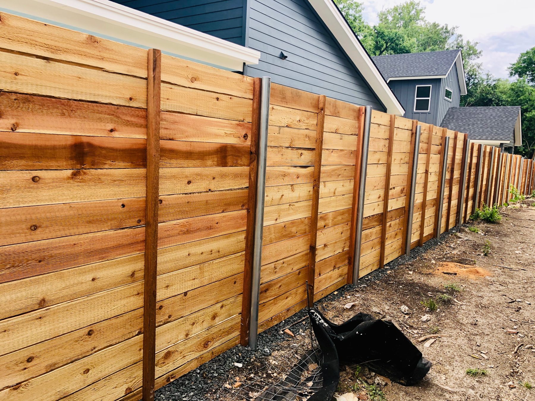 New horizontal wood fence along a property line
